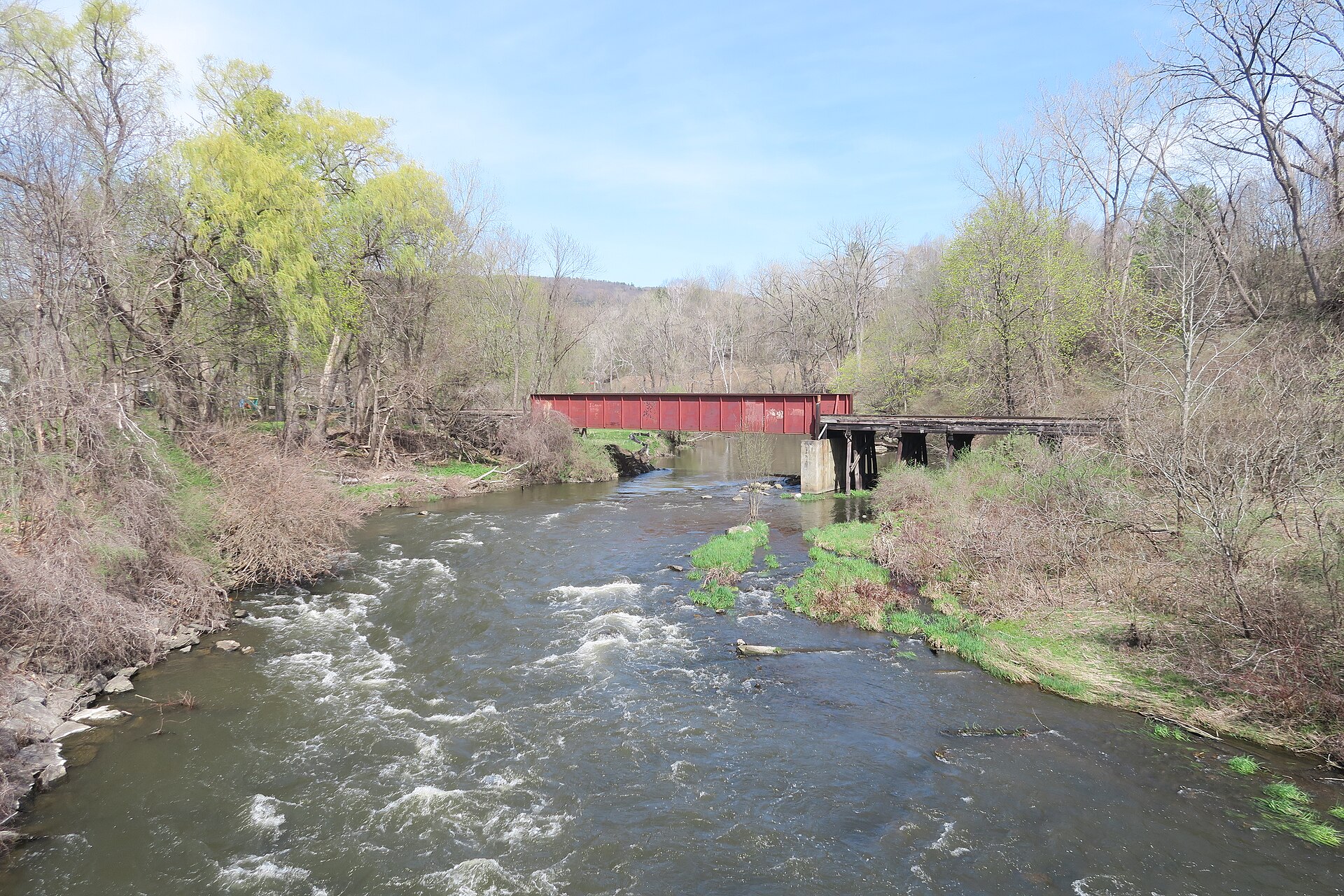The Housatonic River passes below a railroad bridge at Lenox Dale, Massachusetts.
